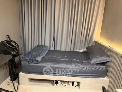 Cozy bedroom with single bed and soft lighting, perfect for relaxation.