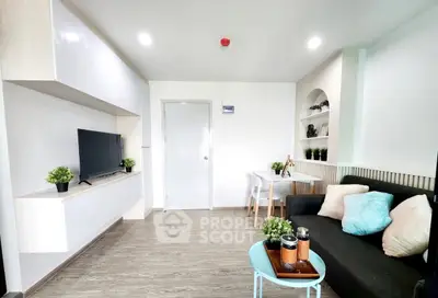 Modern living room with sleek furniture and stylish decor, featuring a cozy sofa and wall-mounted TV.