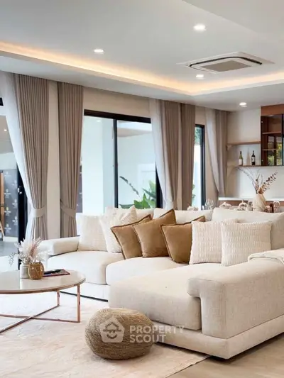 Luxurious living room with elegant decor and large windows for natural light.