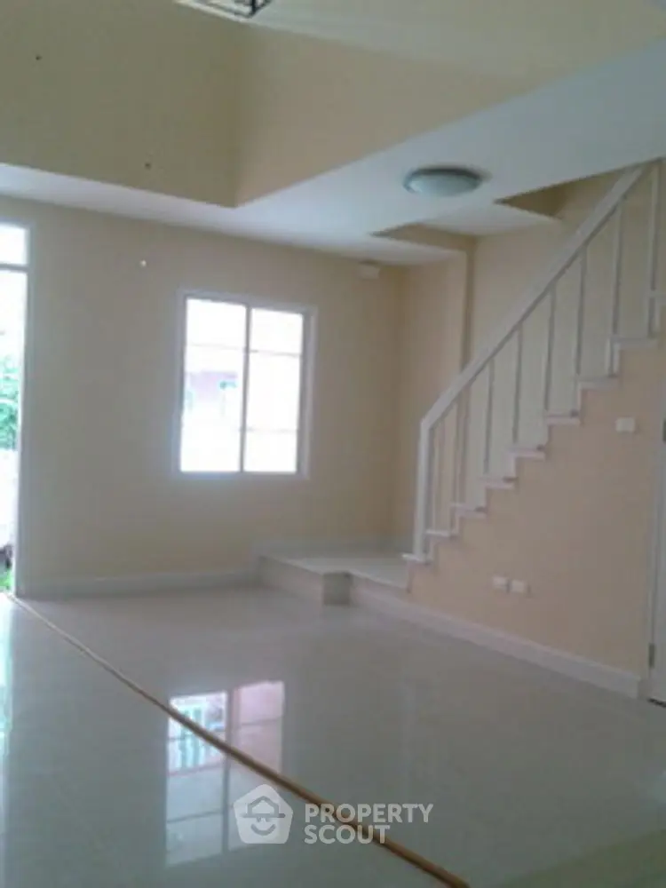 Spacious interior with modern staircase and natural light