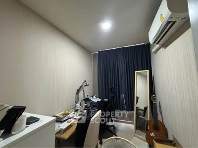 Cozy study room with desk, chair, and guitar, perfect for work or relaxation.