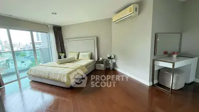 Spacious bedroom with city view and elegant decor in modern apartment