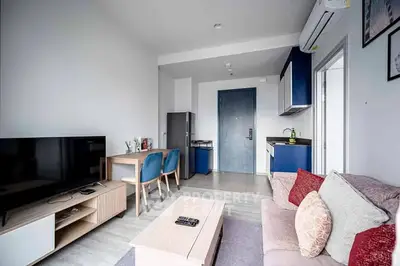 Modern living room with stylish furniture and open kitchen layout