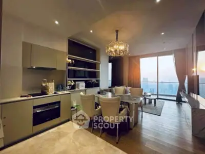 Luxurious open-plan kitchen and dining area with stunning city view and elegant chandelier.