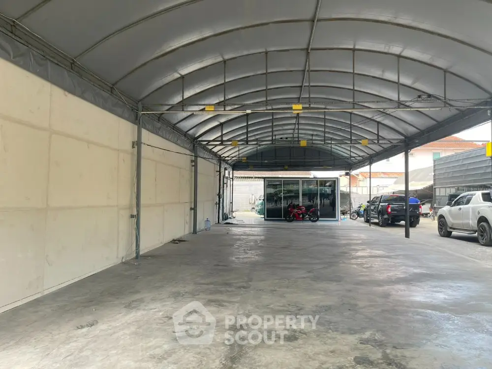 Spacious covered parking area with multiple vehicles and sturdy metal roof.