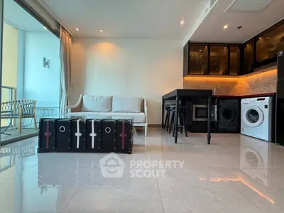 Modern living room with open kitchen and balcony view