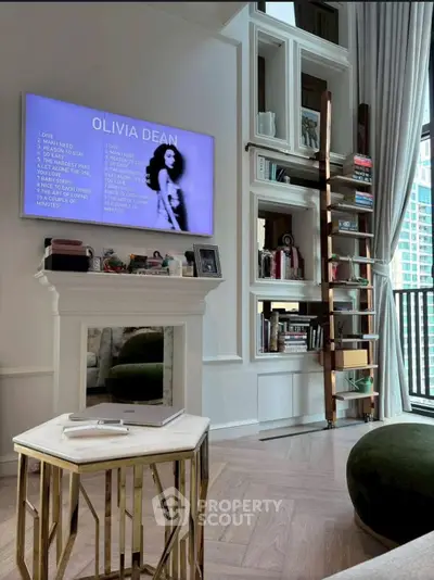 Stylish living room with modern decor, built-in shelves, and a large window offering natural light.
