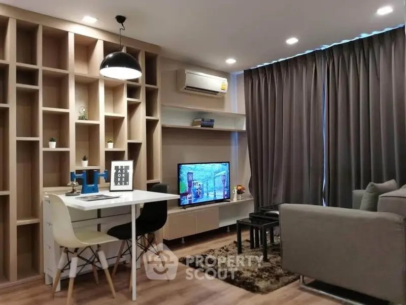 Modern living room with stylish furniture and built-in shelving, perfect for cozy gatherings.