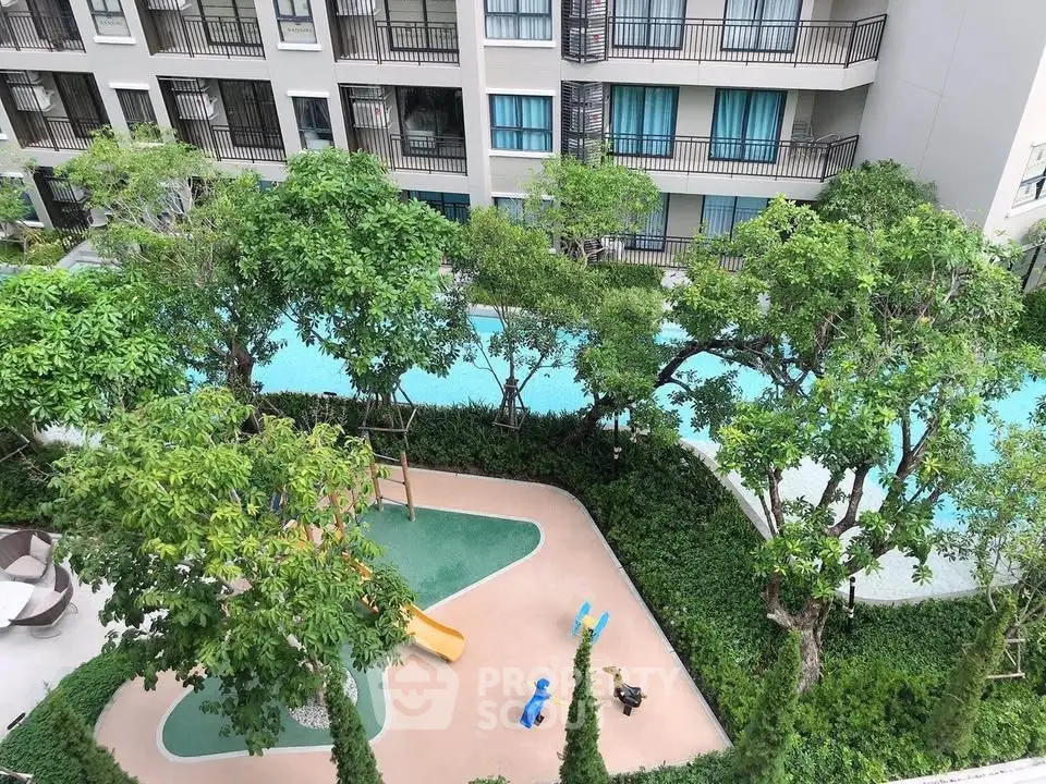 Modern apartment complex with lush garden and pool view
