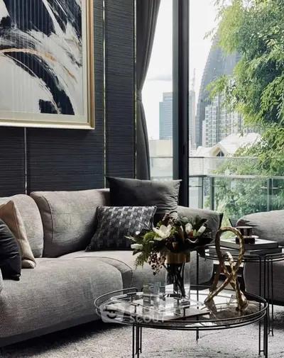 Stylish living room with modern decor and city view, featuring elegant furniture and artistic touches.