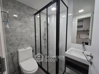 Modern bathroom with sleek shower enclosure and contemporary fixtures