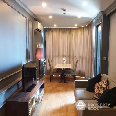 Cozy living room with elegant decor and natural light, featuring a stylish dining area.