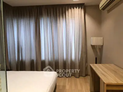 Cozy bedroom with elegant curtains and wooden furniture, perfect for relaxation.