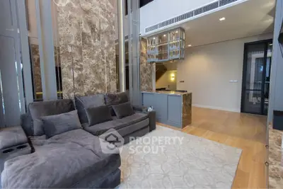 Luxurious modern living room with plush gray sofa and elegant marble accents