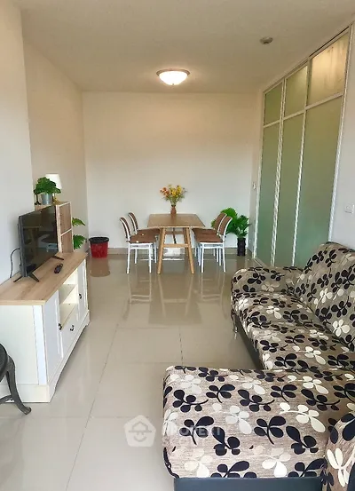 Modern living room with stylish furniture and dining area, perfect for cozy gatherings.