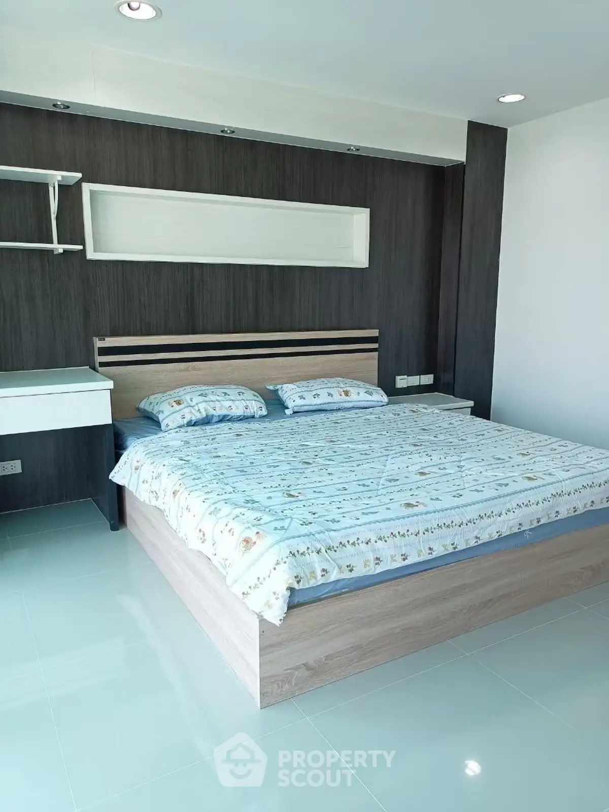 Modern bedroom with stylish bed and sleek design in a bright, airy space.