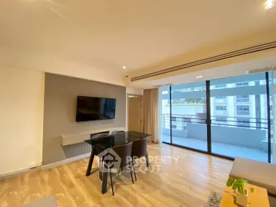 Spacious modern living room with balcony and stylish dining area in a high-rise apartment.