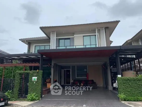 Modern two-story house with spacious driveway and lush greenery