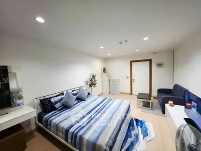 Spacious modern bedroom with stylish decor and cozy ambiance
