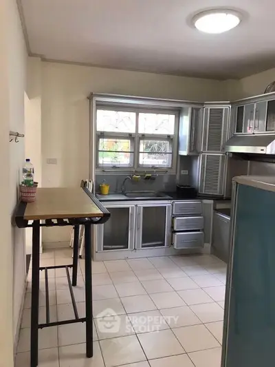 Spacious kitchen with modern cabinetry and ample natural light