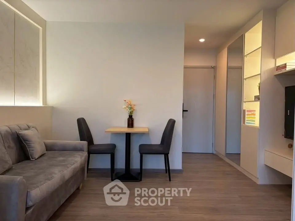 Modern living room with cozy seating and elegant decor in a stylish apartment.