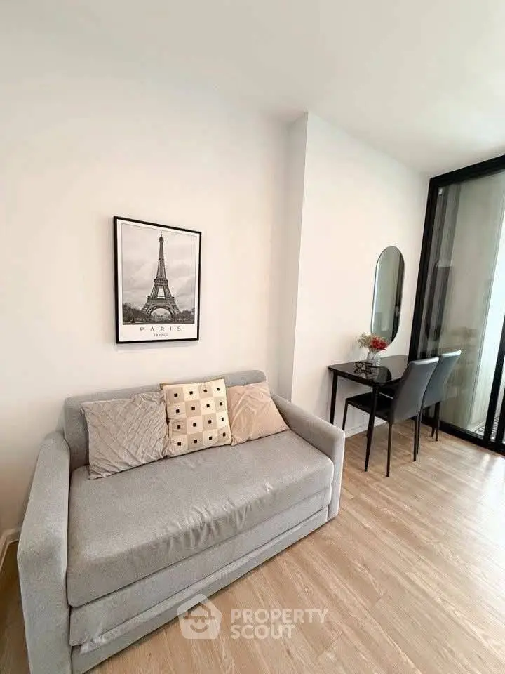 Modern living room with cozy sofa and stylish decor, featuring a chic workspace and elegant flooring.