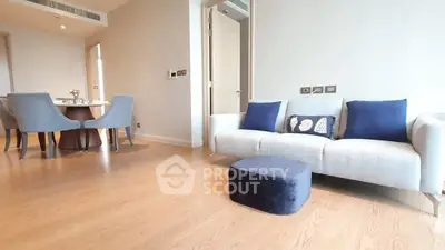 Modern living room with elegant dining area and cozy seating in a stylish apartment.