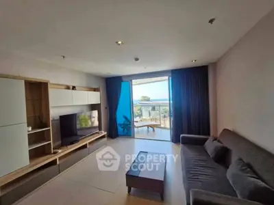 Spacious living room with modern furniture and stunning balcony view