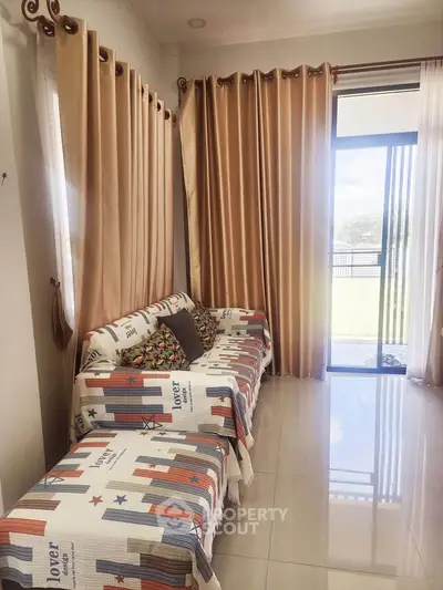 Cozy living room with stylish curtains and comfortable seating, perfect for relaxation.