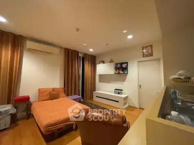 Cozy living room with modern decor and warm lighting, featuring a comfortable sofa and stylish shelving.