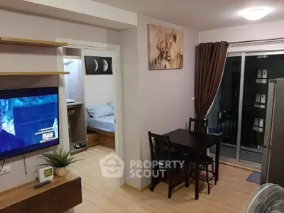 Cozy apartment interior with modern decor, featuring a small dining area and a glimpse of the bedroom.