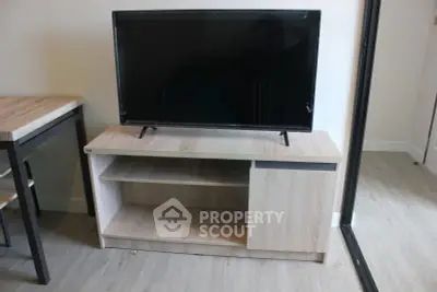Modern living room with sleek TV stand and flat-screen TV, perfect for entertainment setup.