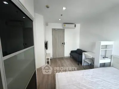 Modern minimalist bedroom with sleek furniture and air conditioning, perfect for urban living.