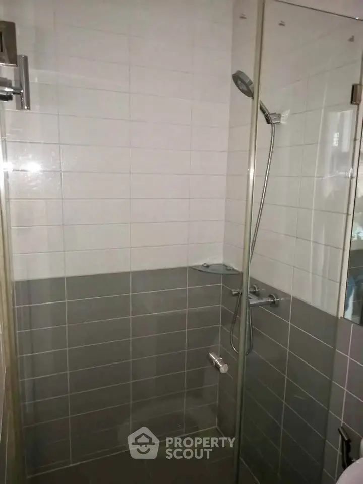 Modern bathroom with glass shower enclosure and sleek tile design