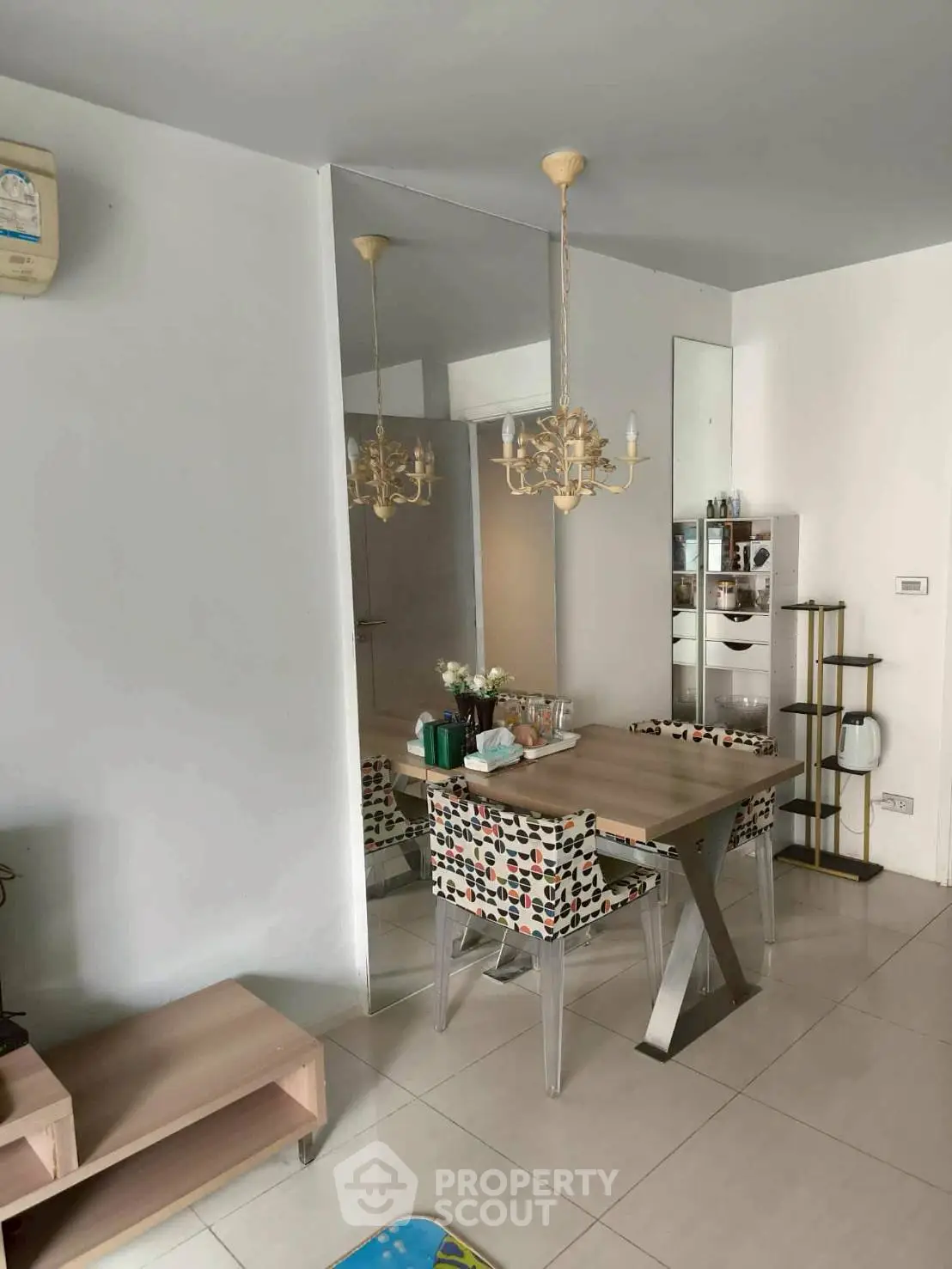 Stylish dining area with modern decor and elegant chandelier in a cozy apartment.