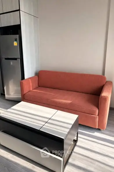 Modern living room with stylish sofa and sleek coffee table in bright apartment.