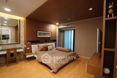 Luxurious bedroom with modern decor and balcony access in upscale apartment.
