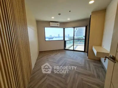 Spacious room with stunning city view and elegant wooden flooring