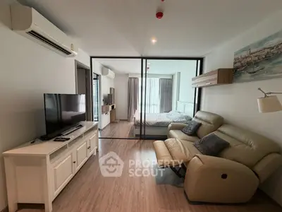 Modern living room with glass partition and cozy seating area