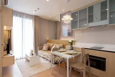 Modern living room with open kitchen, stylish decor, and natural light