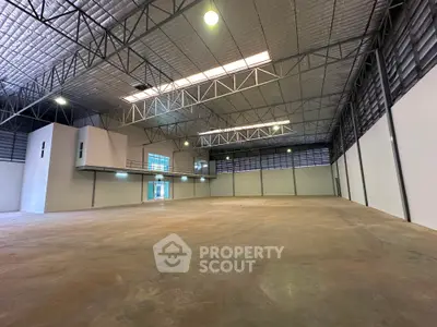 Spacious industrial warehouse with high ceilings and ample natural lighting