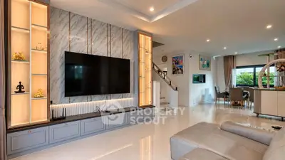 Luxurious modern living room with large TV and elegant decor