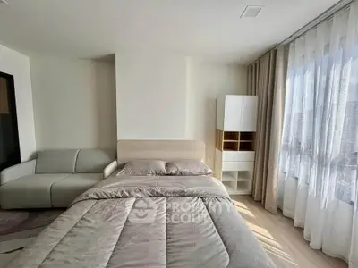 Modern bedroom with cozy bed and natural light through large window