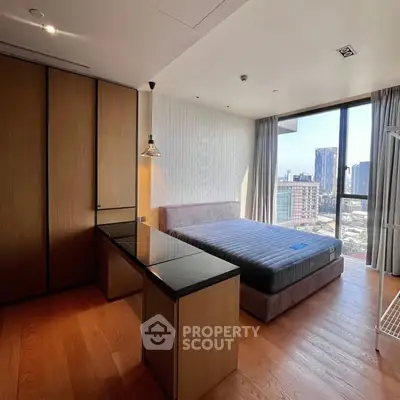 Spacious bedroom with city view, featuring modern design and ample natural light.