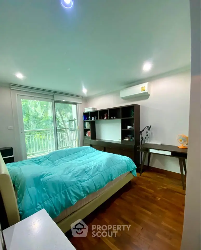 Cozy bedroom with balcony view and modern furnishings