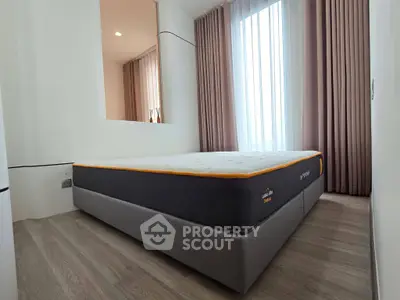 Modern bedroom with large window and stylish curtains in a contemporary apartment.
