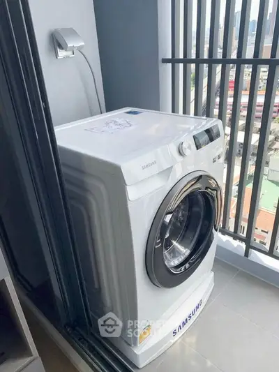 Modern balcony with Samsung washing machine and city view.