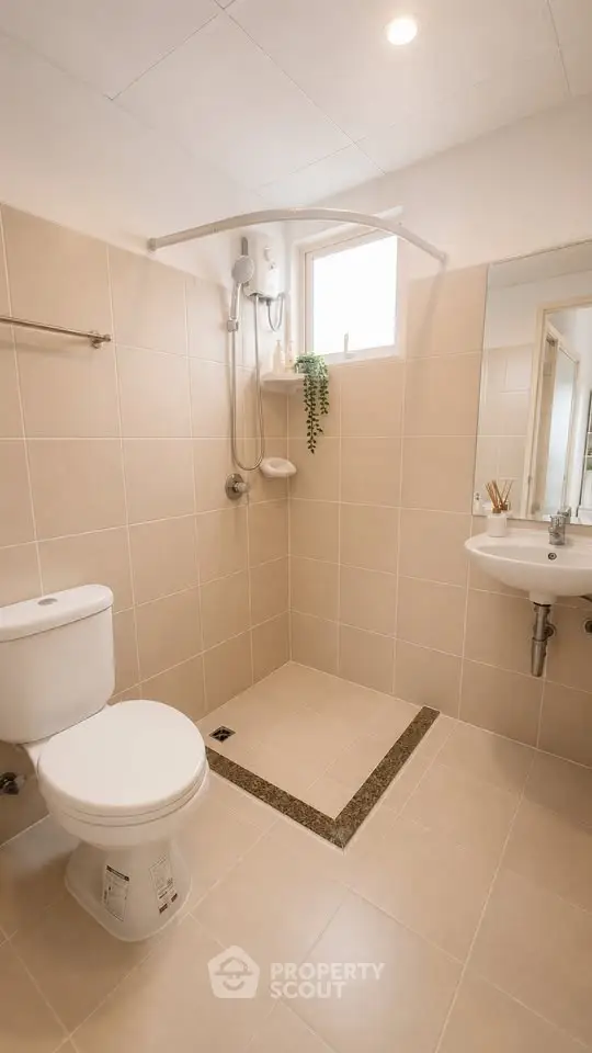 Modern bathroom with sleek fixtures and neutral tiles, featuring a walk-in shower and natural light.