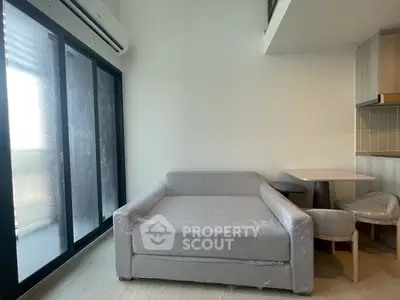 Modern living room with sleek sofa and dining area in a stylish apartment