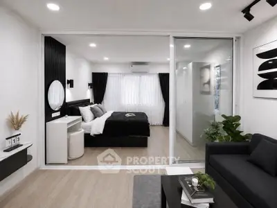 Modern studio apartment with stylish bedroom and living area, featuring sleek decor and natural light.